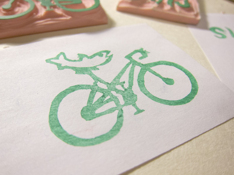 stamp of a fish on a bike